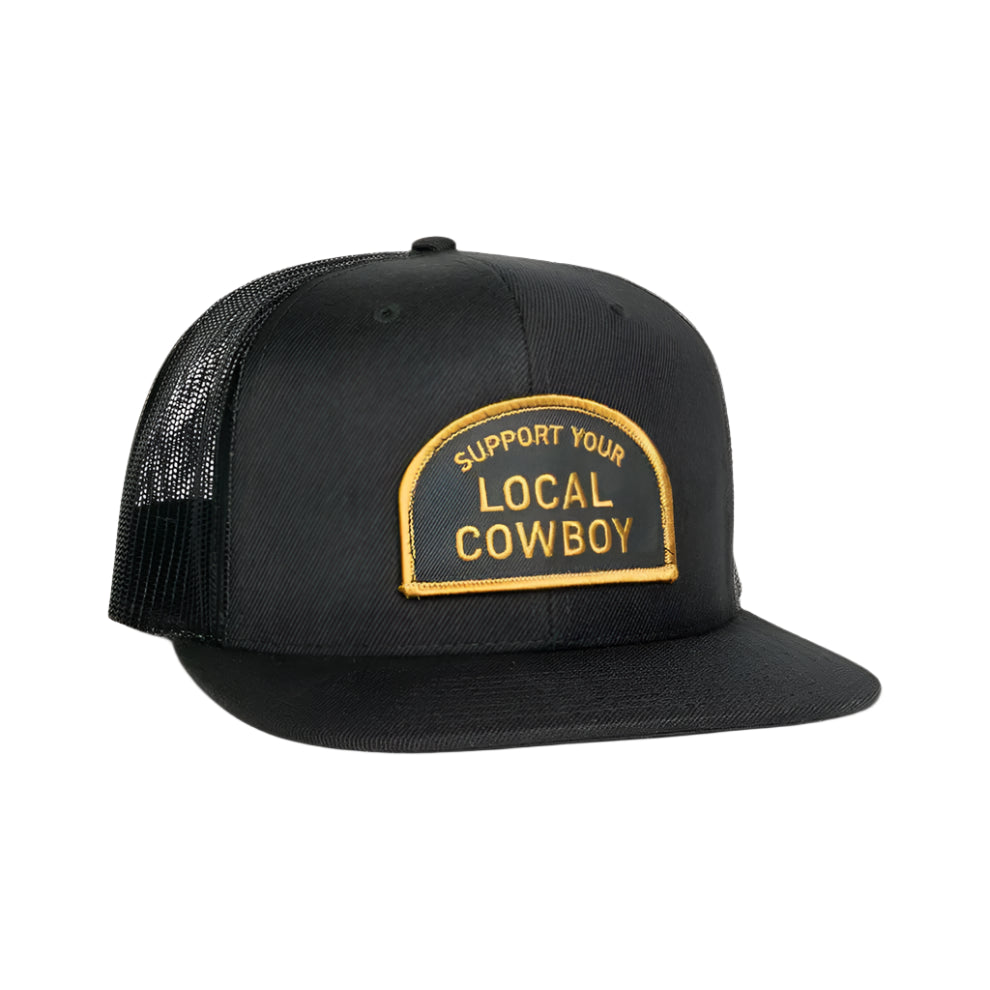 Black trucker snapback hat with a black patch that reads 'Support Your Local Cowboy' in gold with a gold outline.