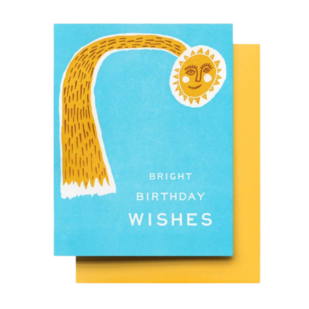 A bright blue card with a yellow smiling sun radiating bright birthday wishes, blank inside.