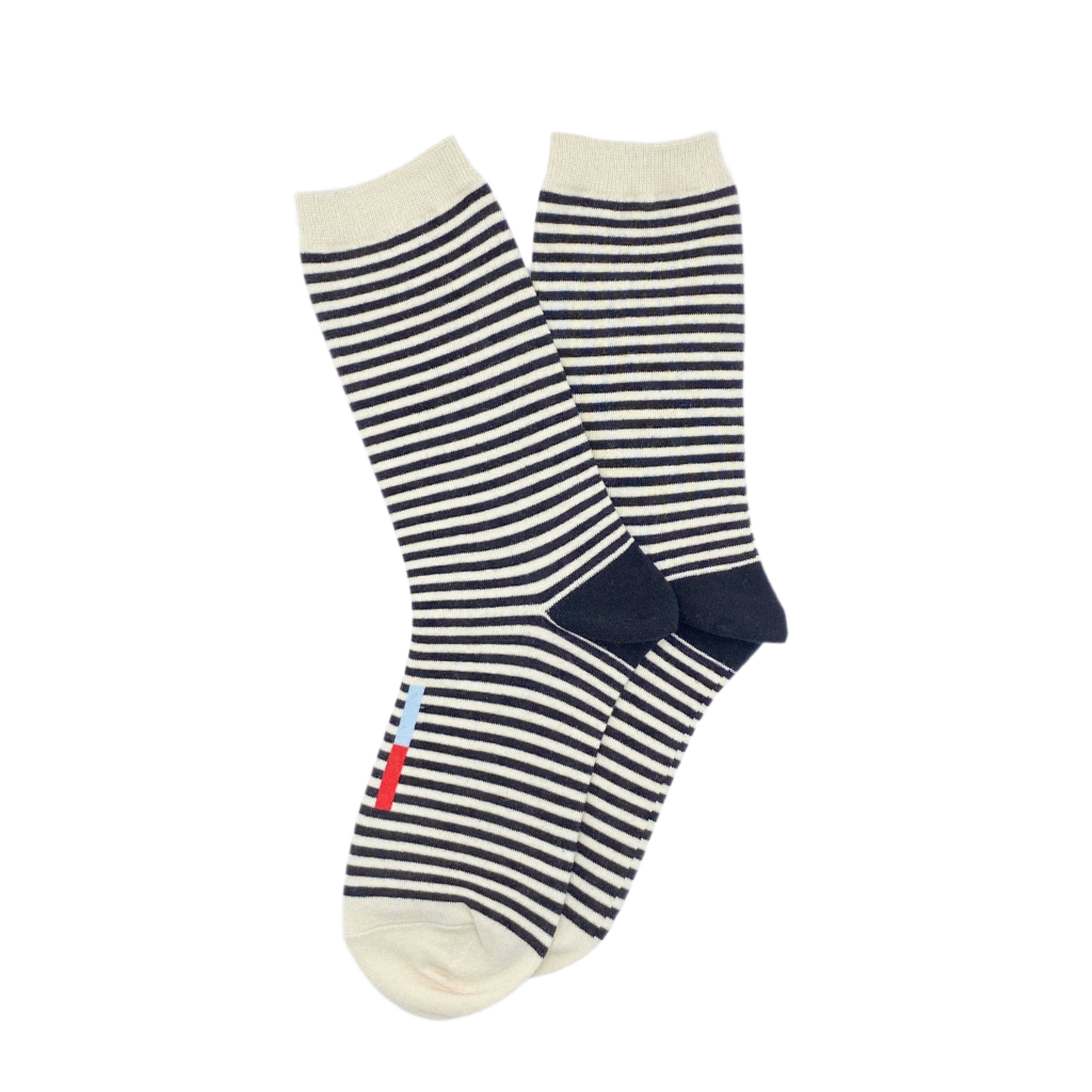 Crew socks with black and white stripes to add a fun pop to any outfit or for being cozy at home.