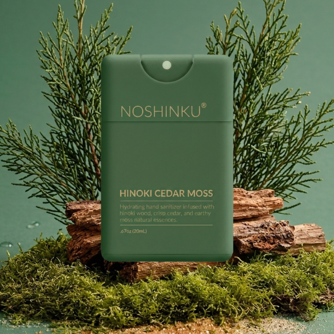 Noshinku Hinoki Cedar Moss hydrating hair serum in a matte sage green bottle, styled on a rustic log surrounded by green moss and pine branches against a matching sage green background.