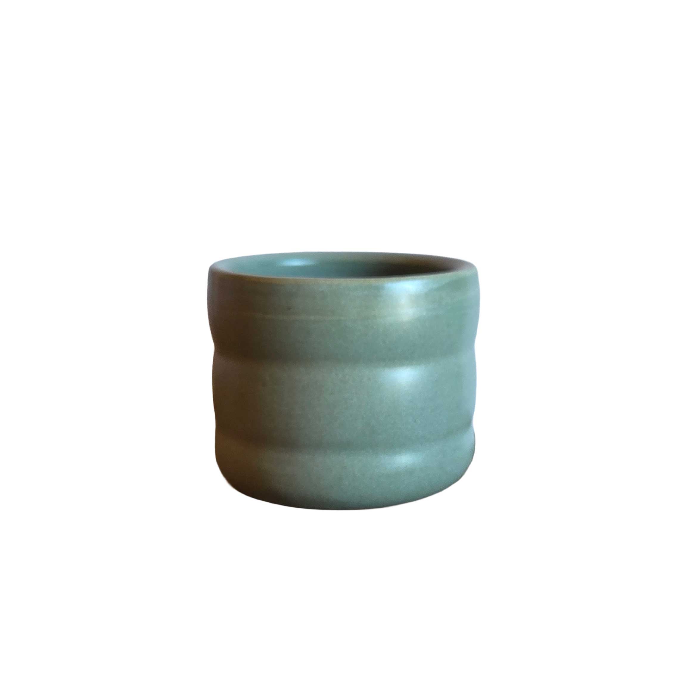 Wiggly tumbler in moss green, 6oz ceramic cup with curvy shape, great for espresso, tea, or adding charm to your table.