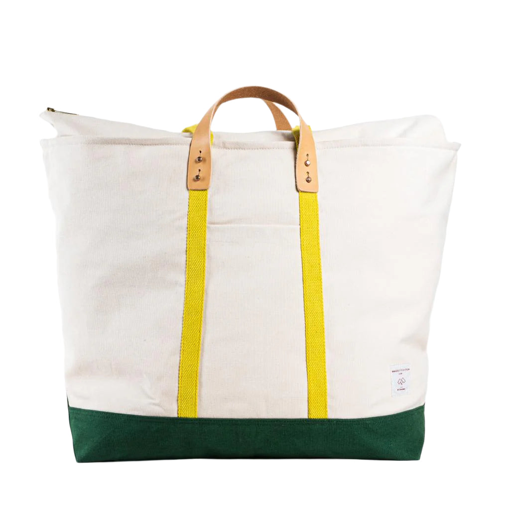 Oversized zipper tote bag, shell canvas with earth green bottom and yellow straps, jumbo size for travel or beach days.