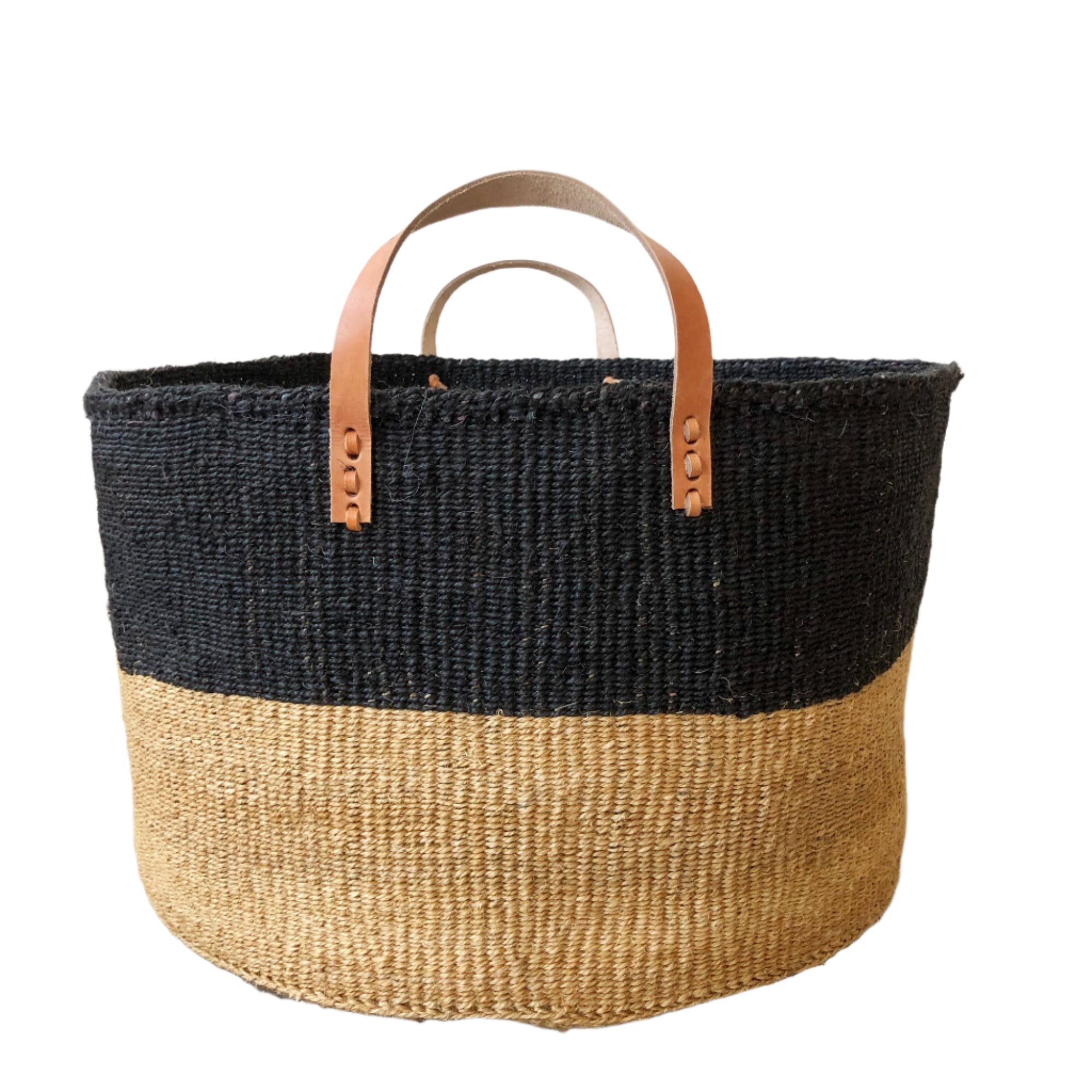 A two toned, neutral and balck, extra large floor basket with leater straps. Perfect for blanket or towel storage.