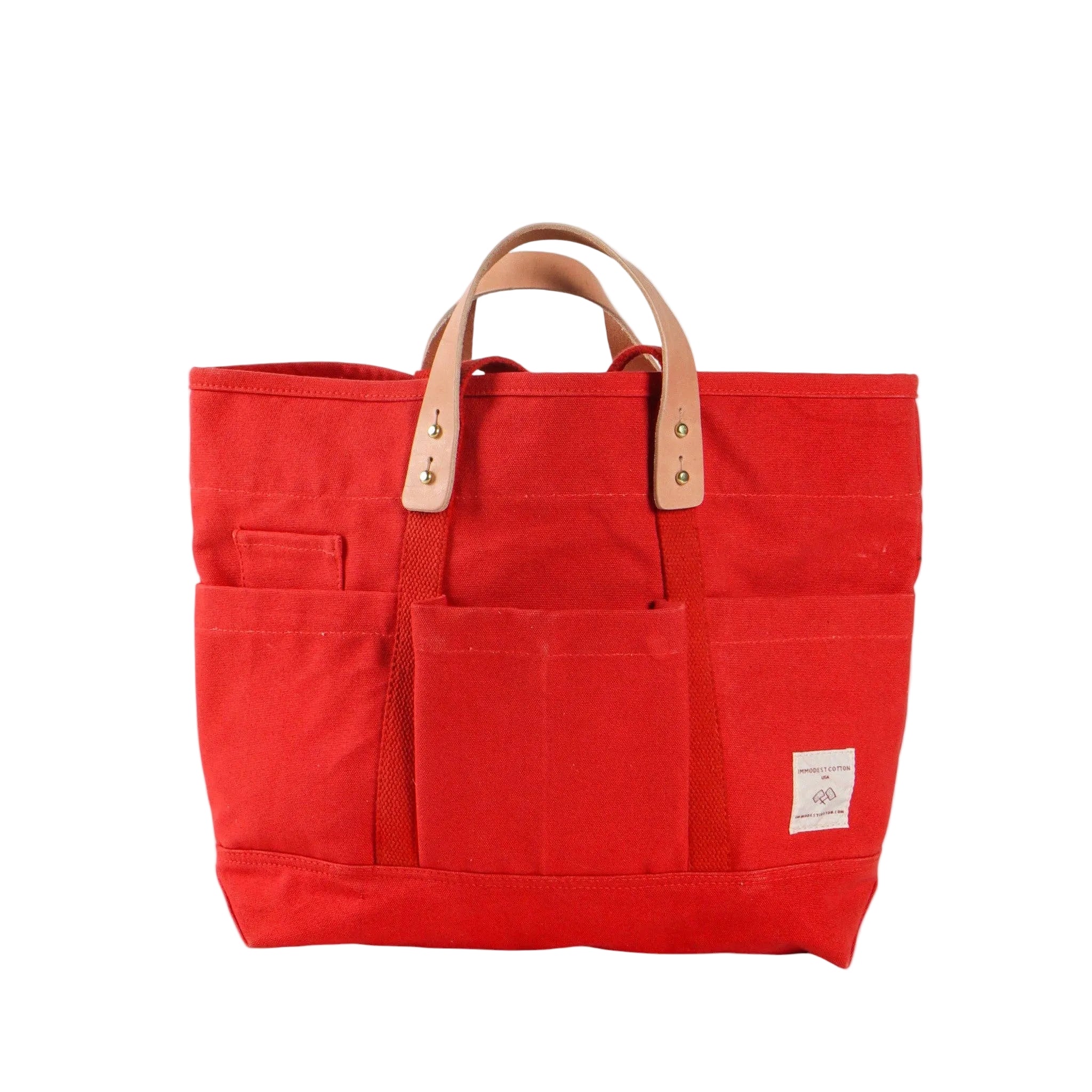 Red tote bag with brown handles on a white background