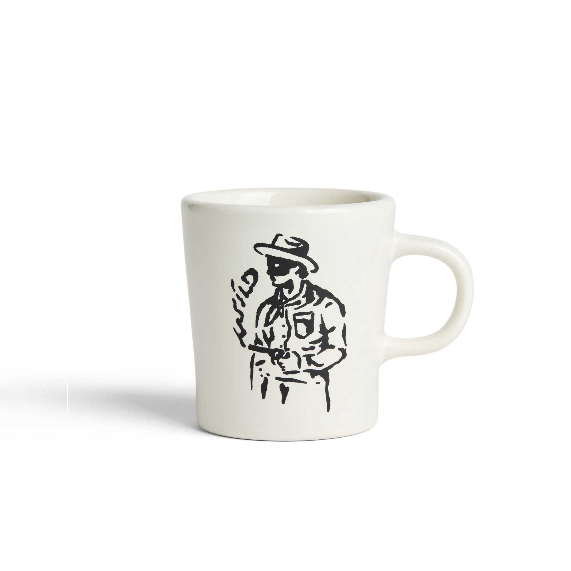 Natural ceramic mug featuring a cowboy holding smoking gun with the smoke spelling 'wild,' 9oz size for coffee or tea.