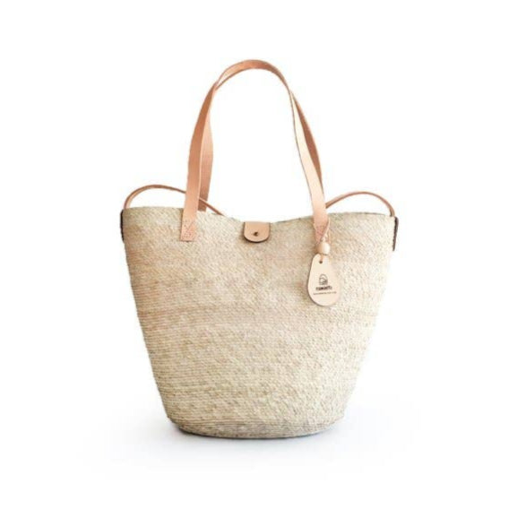 Small woven palm fiber bucket bag with leather straps, a chic everyday bag for errands or outings.