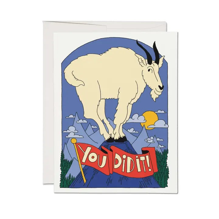 Celebratory card with a goat standing on top of a mountain. A "you did it" banner underneath. Blank on the inside