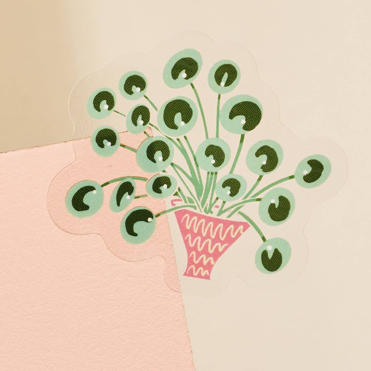 2 inch decorative transparent sticker with the illustration of a Pilea plant.