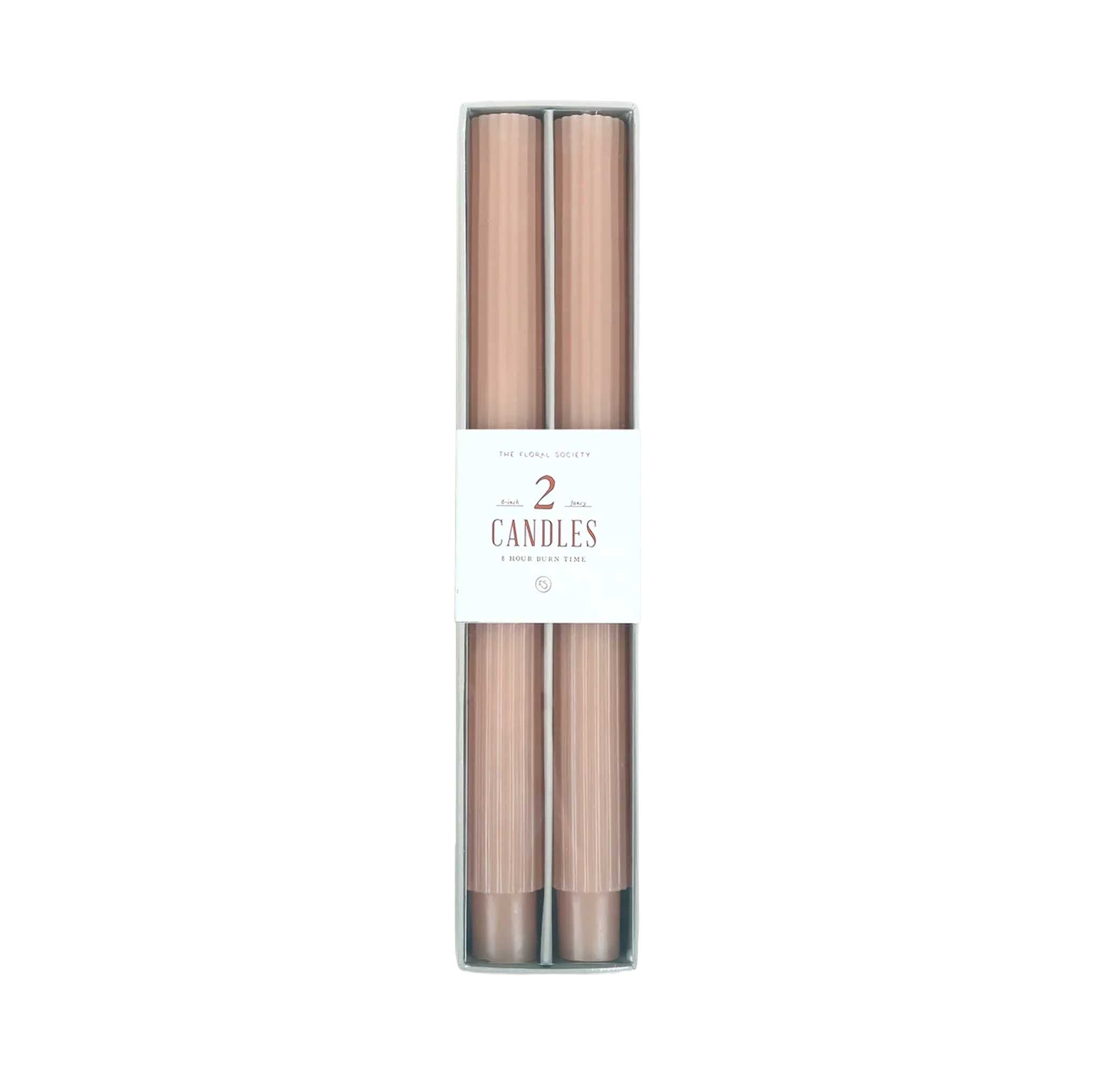 Pair of 10-inch ribbed taper candles in a blush pink, long-lasting with up to 10 hours burn time each.