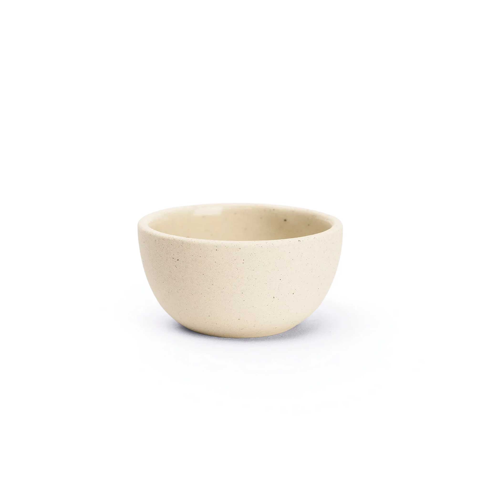 Small handmade ceramic bowl 4x4.25 with neutral matte speckled finish and glazed interior, ideal for snacks or sides.