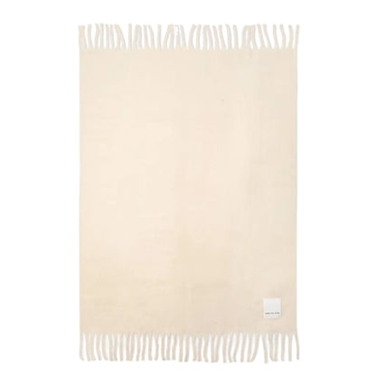 Beige throw with white fringe on a white background