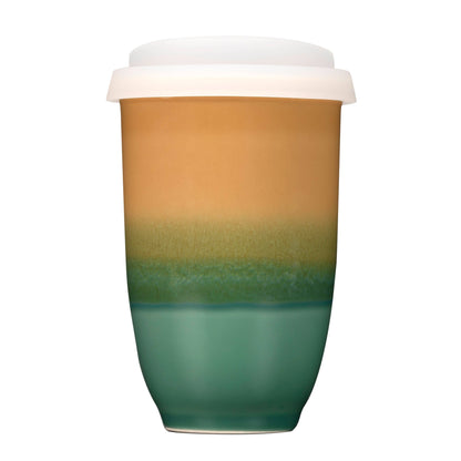 Gradient-colored ceramic tumbler with a white lid on a white background