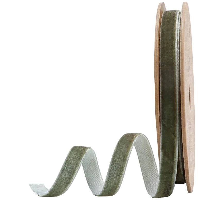 Spool of green ribbon on a white background