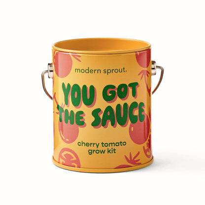 A cylindrical metal canister-style container for a cherry tomato grow kit, branded 'modern sprout.' with the phrase 'YOU GOT THE SAUCE' in green text on a yellow-orange background with tomato illustrations.