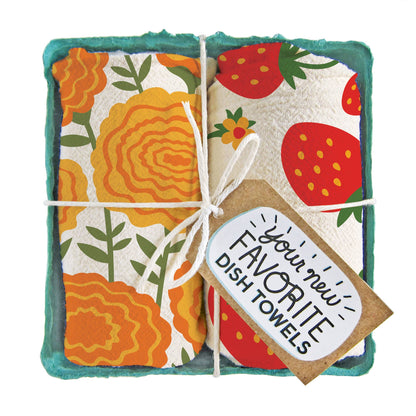 Pair of cotton tea towels with marigold blooms and juicy strawberry prints, eco-friendly, packed in a produce-style container. Perfect for any gift.