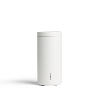White 12oz Nomad tumbler with 360° sip lid, twist-open for easy drinking, reseals securely, perfect for hot or cold drinks.