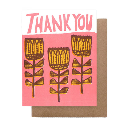 A thank you card with a bright pink background and fun fantastical yellow flowers. Blank inside.