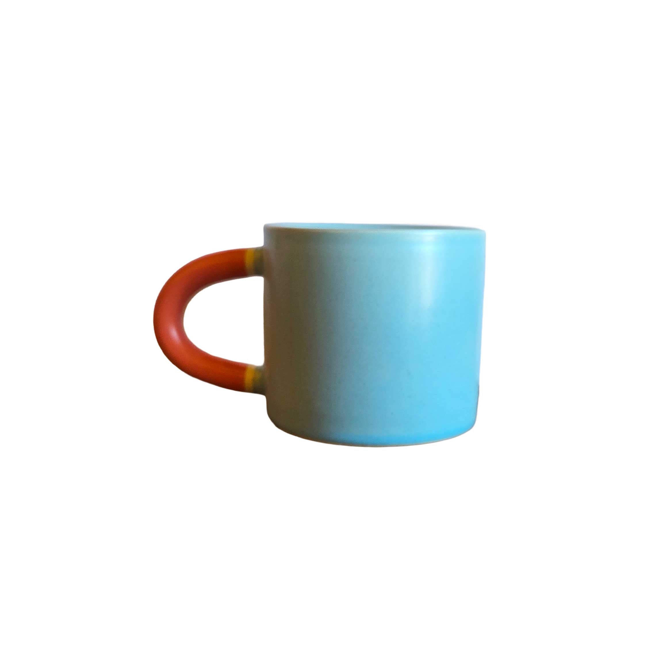 Classic ceramic mug in sky blue with bright red handle, 10oz size, perfect for morning coffee, tea, or playful kitchen décor.