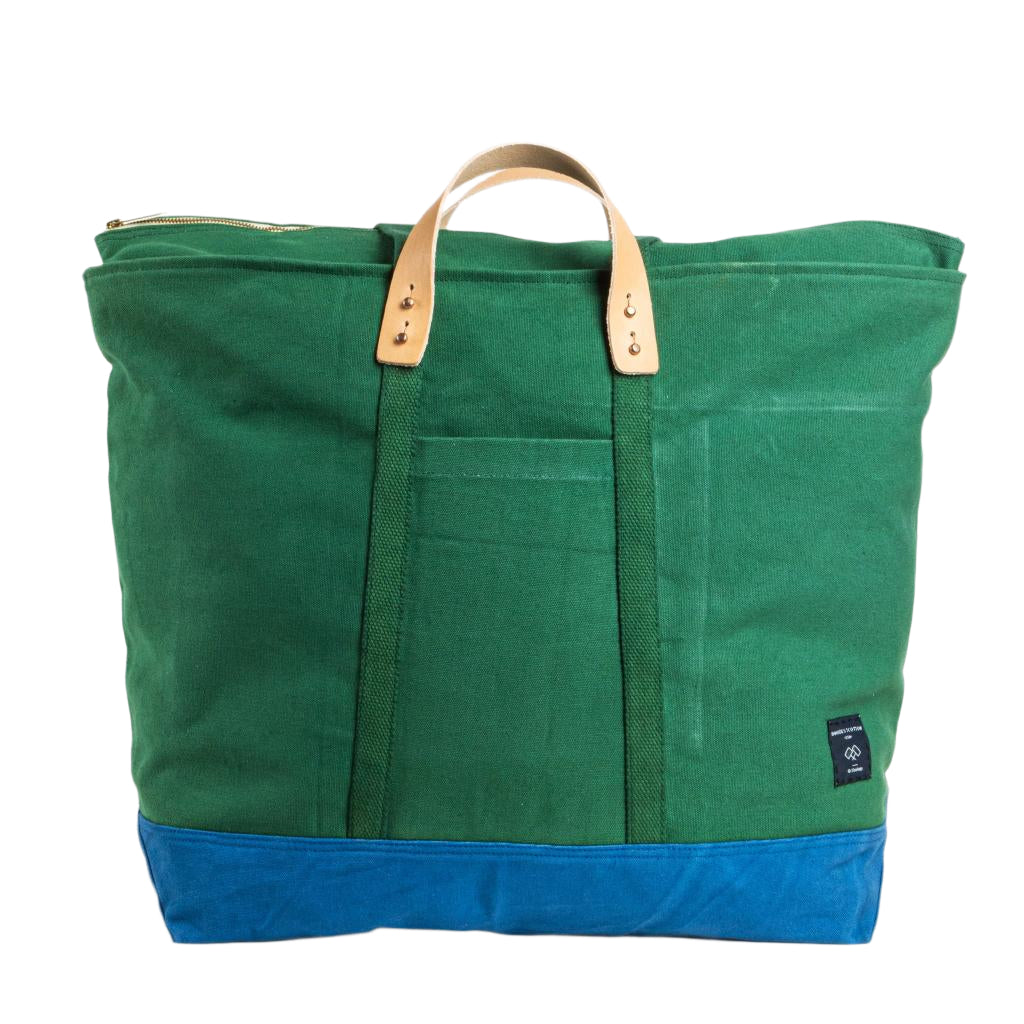Extra-large canvas tote in pine green and ocean blue with zip closure and sturdy handles for travel or beach days
