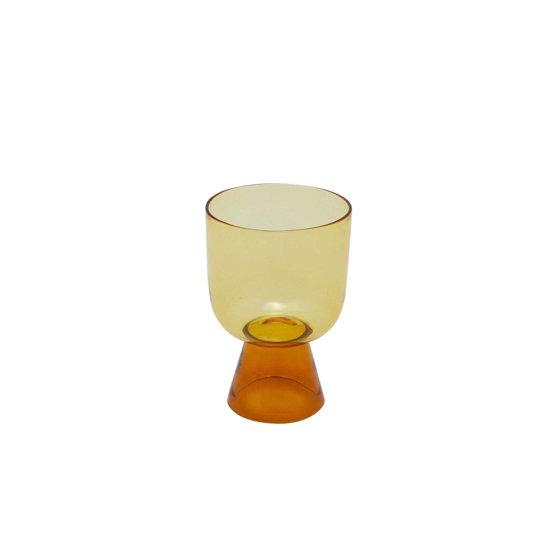 Hand-blown short tumbler in orange jewel tone glass, artisanal cup ideal for cocktails, water, or colorful table settings.