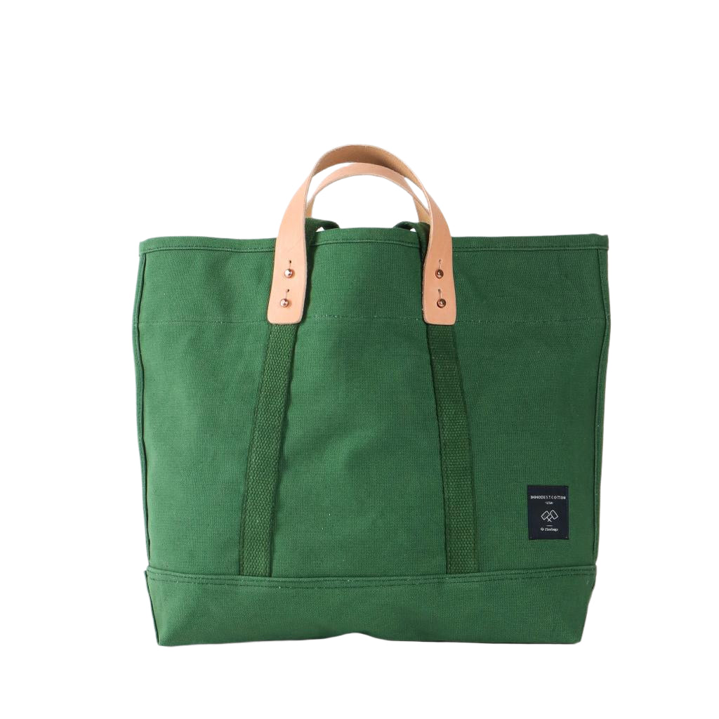 Small tote bag in pine green canvas with short handles, compact everyday size for errands or travel.