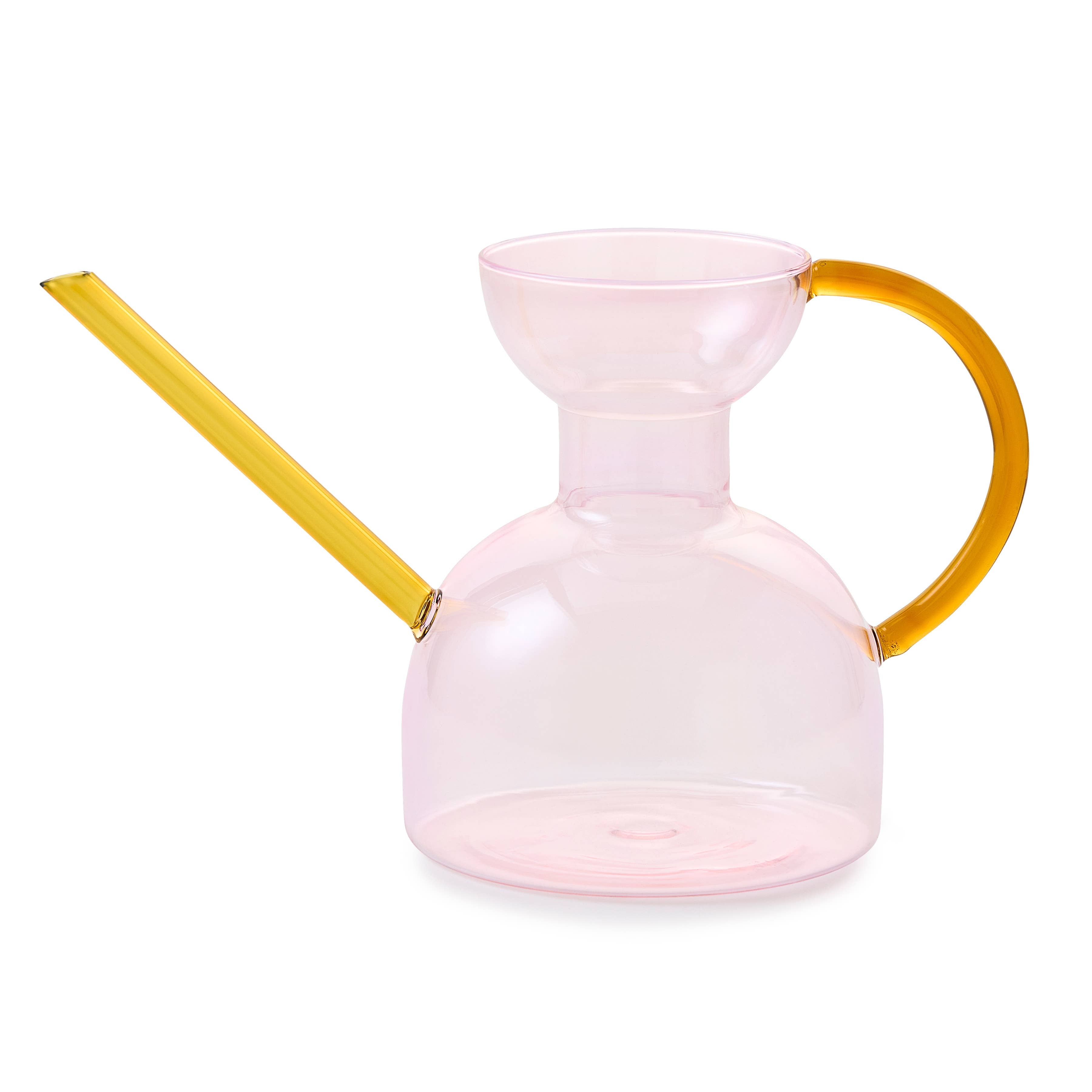 Pink glass pitcher with yellow handle and spout on a white background