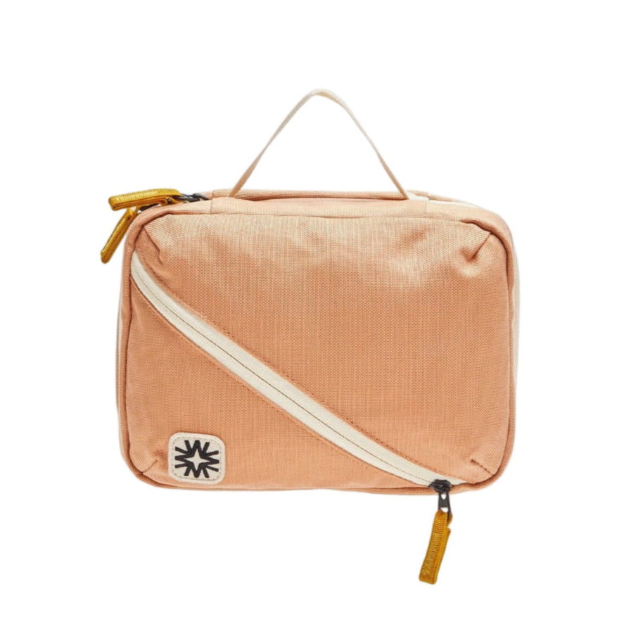 Peach toned canvas toiletry pack two main compartments and small front organizers. Perfect for travel organization.