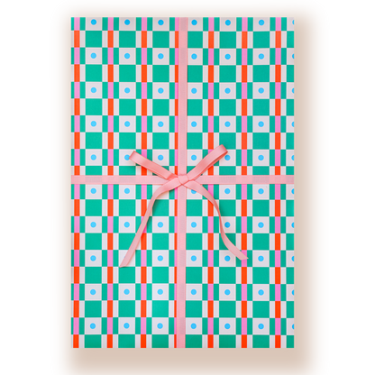 A rectangular gift box wrapped in a colorful geometric patterned paper with a pink ribbon tied in a bow at the center, shown on a white background.