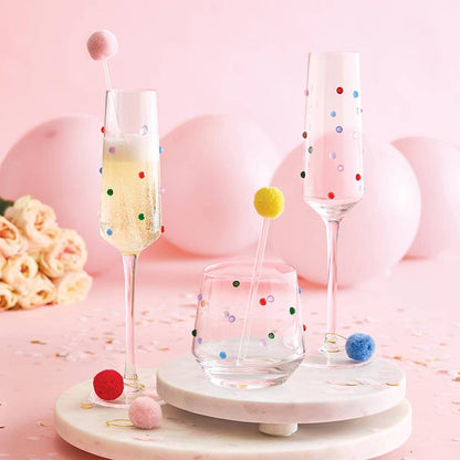 Set of polka dot glasses on a pink background with decorative elements.