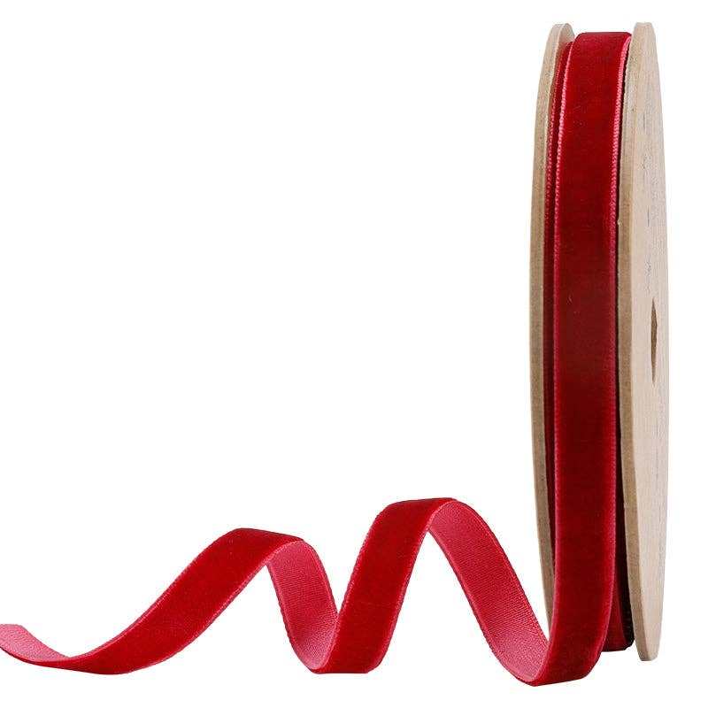 Spool of red ribbon on a white background