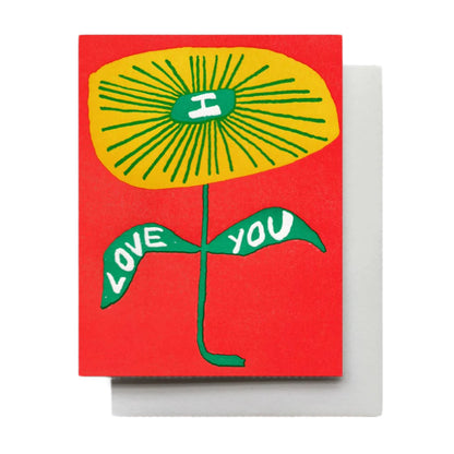 A bold red background with a whimsical yellow flower with I Love You written on the petals, blank inside. 