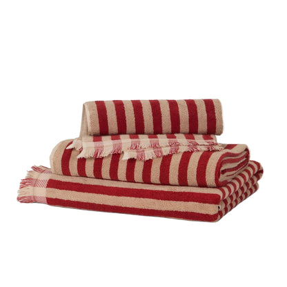 Red and beige striped blanket on a white background