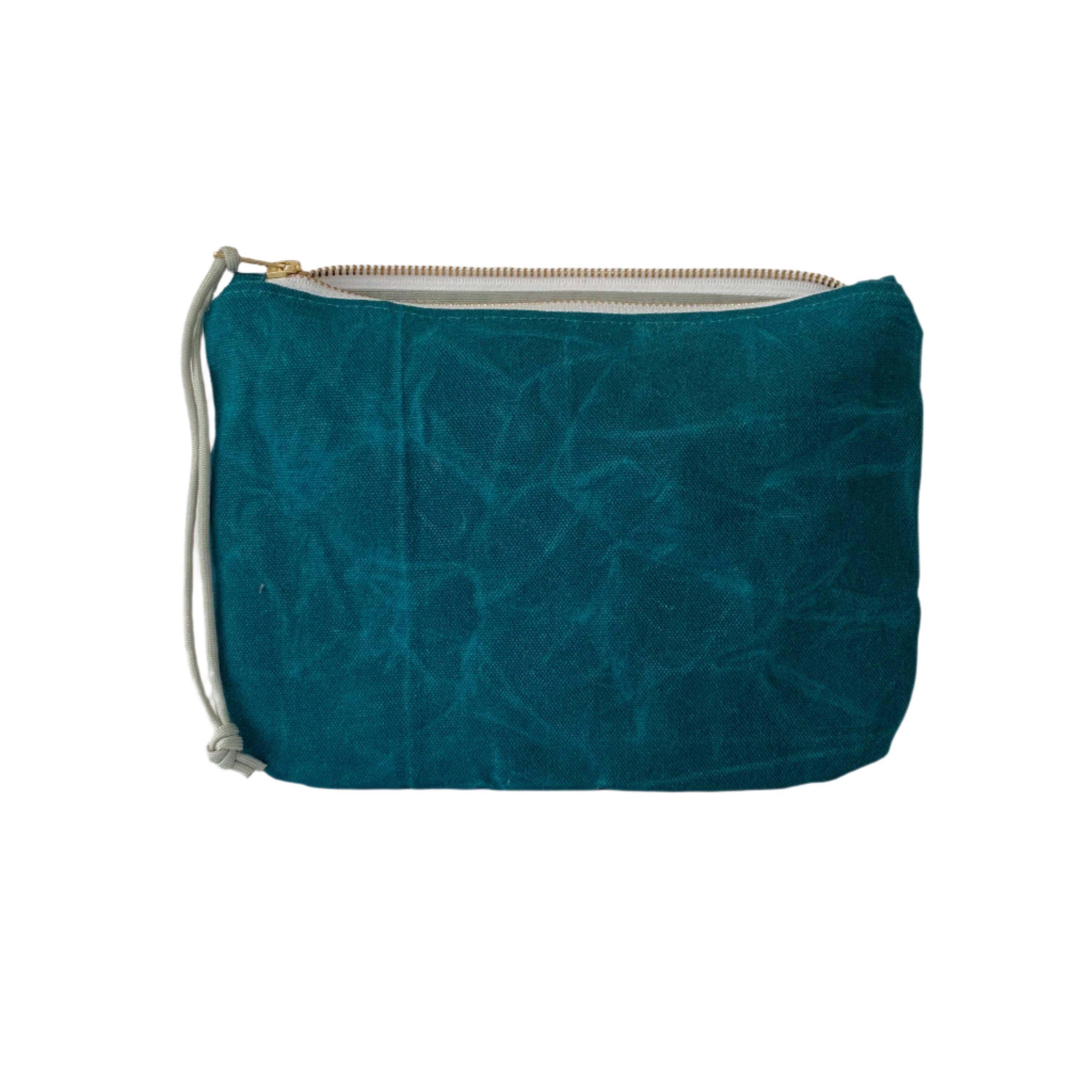 Waxed canvas clutch in marine blue with zipper closure, compact durable design for carrying essentials or travel.