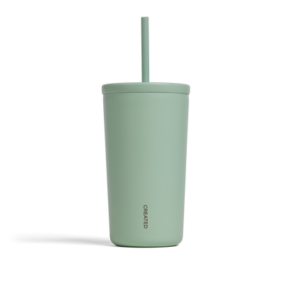 A matte sage green insulated tumbler with a matching lid and straw, set against a plain white background.