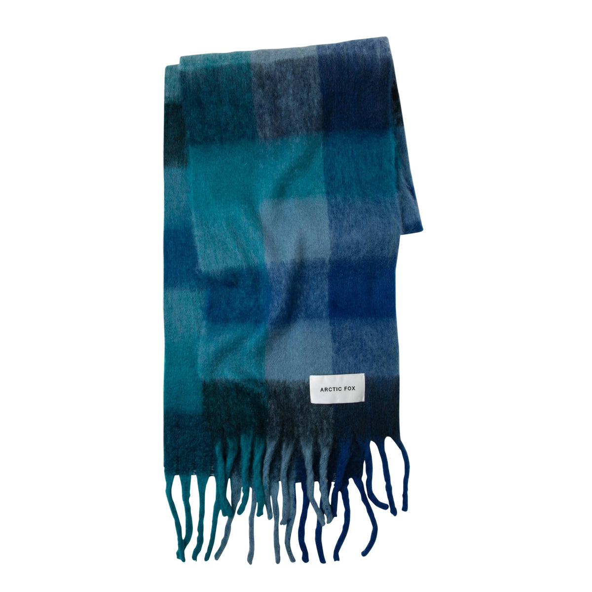 A folded plaid scarf in shades of blue and teal with fringed ends and a small white brand label, photographed on a clean white background.