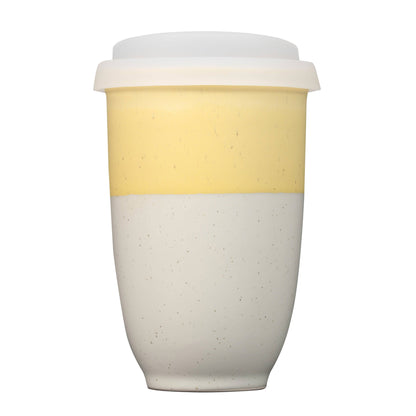 Two-toned ceramic cup with a yellow top and beige bottom on a white background