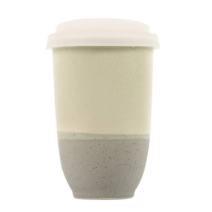 Two-toned ceramic cup with beige top and speckled gray bottom on a white background