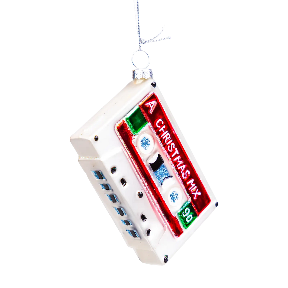 A Christmas ornament shaped like a retro cassette tape, featuring a white plastic body with a red label that reads 'CHRISTMAS MIX 96' and small blue and green details, hanging from a silver string against a white background.