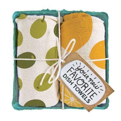 Pair of cotton tea towels with olive branches and bright lemon prints, eco-friendly, packed in a produce-style container. Fun for a pop of fun in the kitchen.