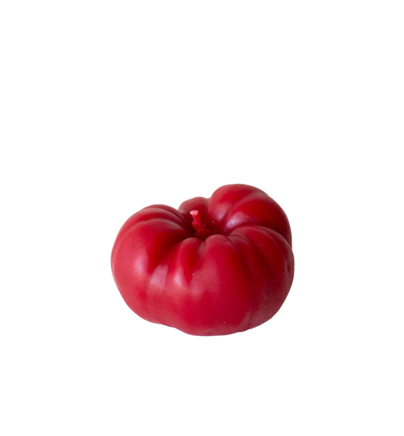 Red tomato candle on a white background