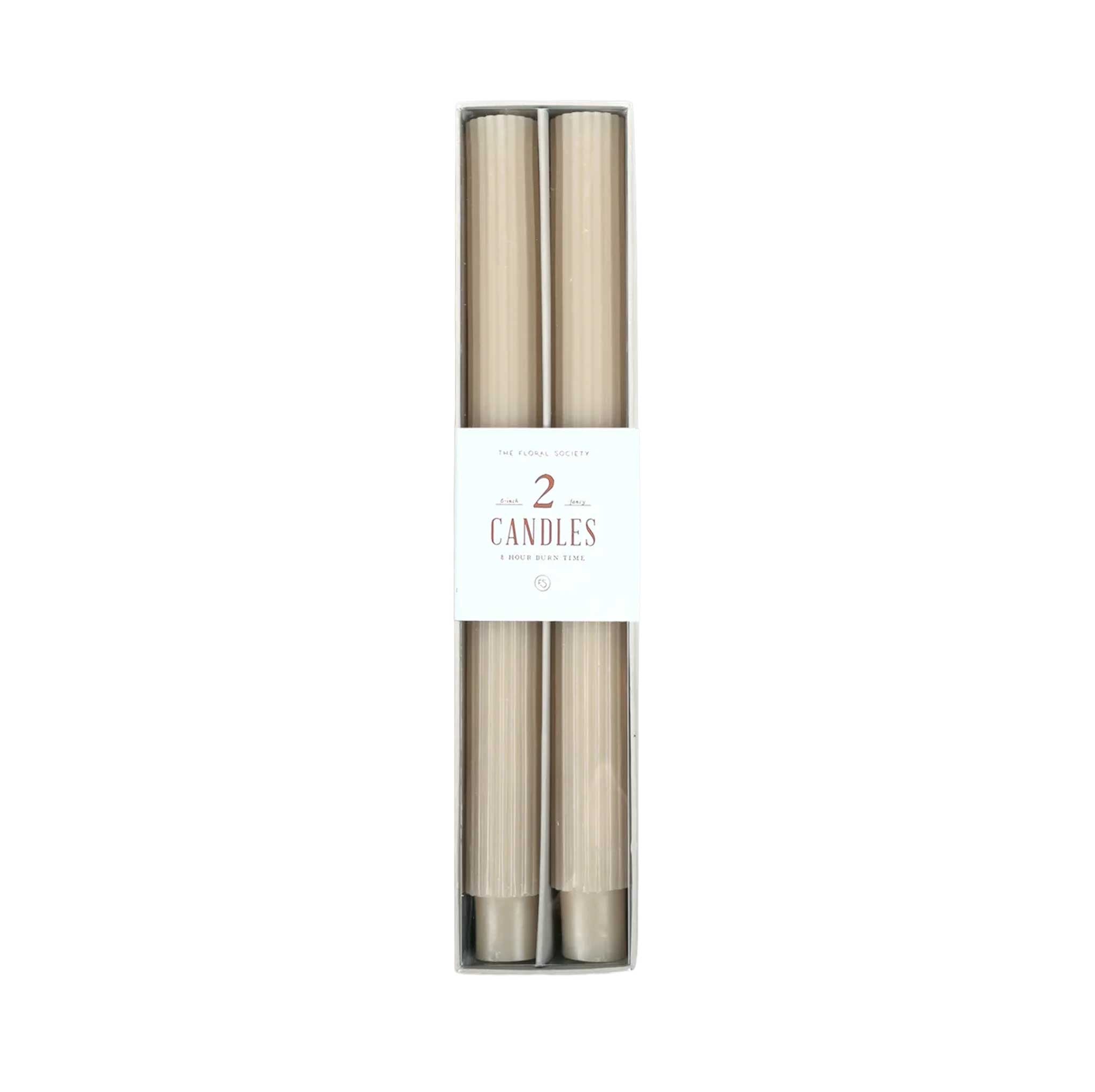 Pair of 10-inch ribbed taper candles in warm partchment tone, long-lasting with up to 10 hours burn time each.